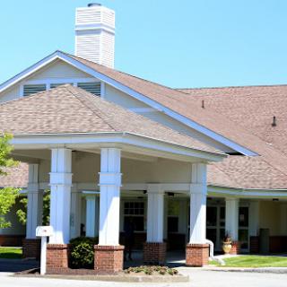 A welcoming residential building with a spacious front entrance and lush landscaping.