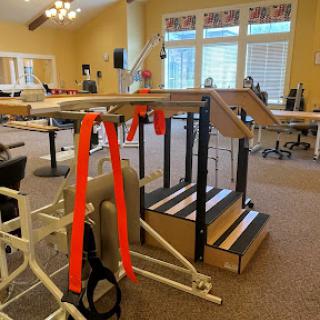 A rehabilitation exercise area featuring therapy equipment and stairs designed for physical therapy sessions.