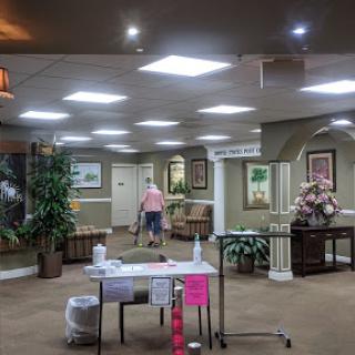 A spacious and well-decorated lobby area with bright lighting and plants.