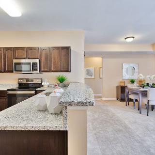 A modern open-concept kitchen and dining area featuring sleek appliances and elegant decor.