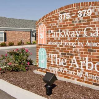 A sign for Parkway Gardens and The Arbors, indicating an assisted living facility.