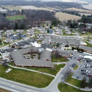 An aerial view of a suburban residential area showcasing various buildings and the surrounding landscape.