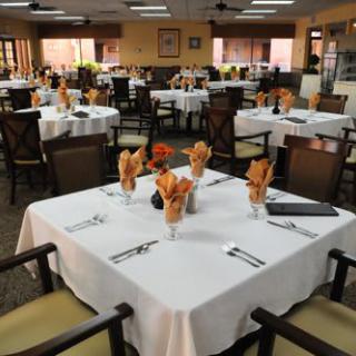 A neatly arranged restaurant dining area with tables set for guests.