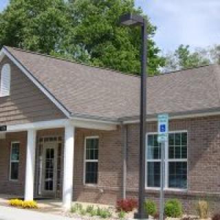 A small brick office building with a front entrance and windows.