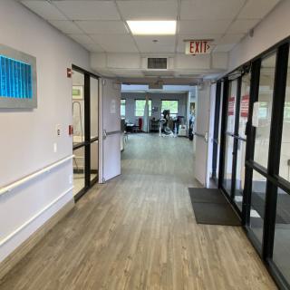 A view down a hallway with glass doors at the entrance.