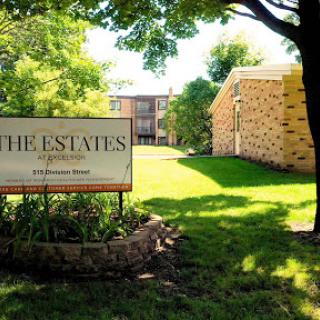 A welcoming view of The Estates apartment complex, featuring well-maintained landscaping and inviting architecture.