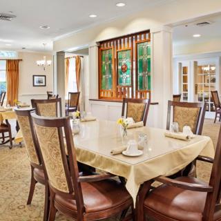 An elegantly decorated dining room with neatly arranged tables and chairs.