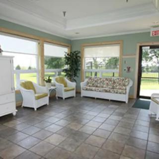 A bright waiting room with comfortable seating and large windows.