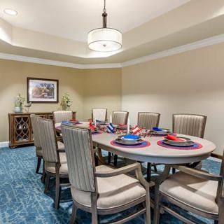 A beautifully arranged dining room featuring a set table with elegant place settings and comfortable chairs.