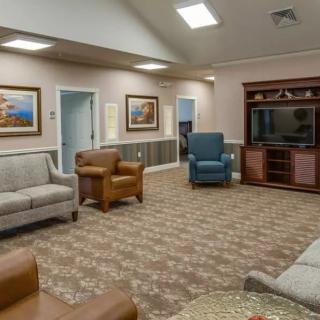 A cozy living room with comfortable seating and a TV entertainment center.