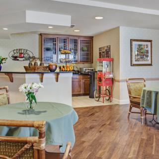 A cozy cafe interior with tables, chairs, and decorative elements.