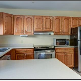 A modern kitchen featuring wooden cabinets and stainless steel appliances.