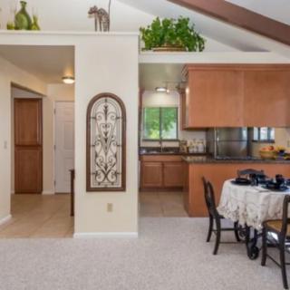 A cozy home interior featuring a kitchen and dining area in an open space layout.