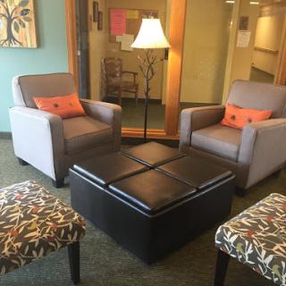 A cozy living room setup featuring two armchairs, a stylish coffee table, and a warm lamp.