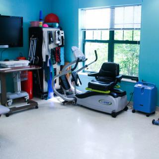 A well-equipped physical therapy room with various exercise machines and tools.