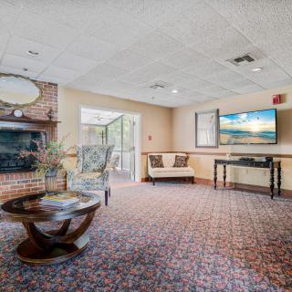 A cozy living room with a fireplace, television, and comfortable seating.