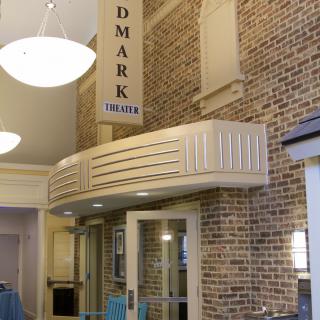Interior view of the Landmark Theatre entrance with brick walls and overhead lighting.
