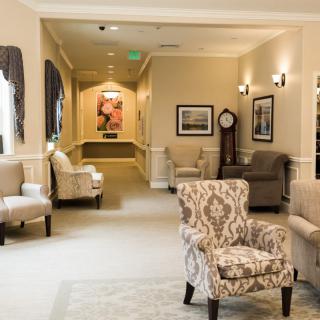 A cozy lobby area featuring comfortable armchairs, warm lighting, and elegant decorations.
