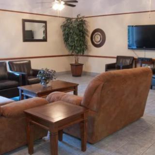 A comfortable living room with sofas, a coffee table, and a mounted television.