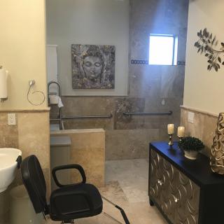 A modern bathroom with elegant decor and seating.