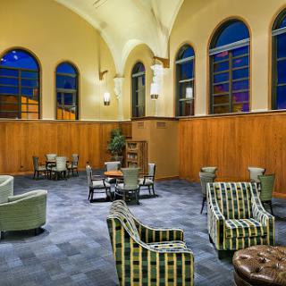 A cozy lounge area featuring stylish seating arrangements and warm architectural details.
