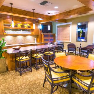 A modern bar area with wooden furniture and ambient lighting.
