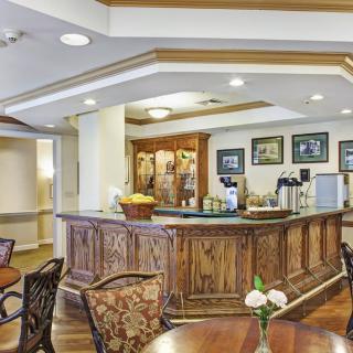 A cozy cafe interior featuring a wooden counter and seating area.