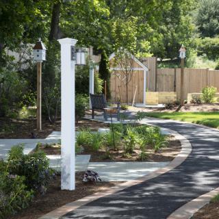 A serene garden pathway surrounded by lush greenery.