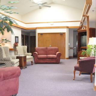 A cozy waiting room with comfortable seating and warm lighting.