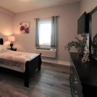 A cozy bedroom with modern furnishings and a warm ambiance.