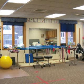 A physical therapy room equipped with various rehabilitation tools and exercise equipment.
