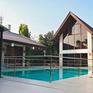 A modern house with a spacious swimming pool in the backyard.
