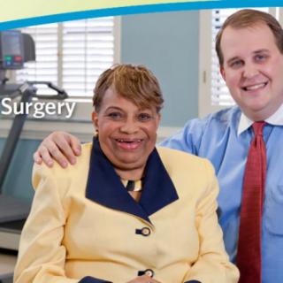 A smiling man and woman posing together in a medical setting.