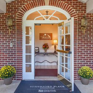 A welcoming entrance with open doors leading into a cozy interior.