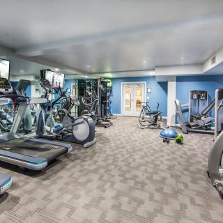 A well-equipped gym with treadmills, stationary bikes, and weights for fitness enthusiasts.