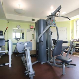A well-equipped gym with various exercise machines and workout equipment.