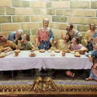 A detailed sculpture representation of the Last Supper, depicting Jesus and his disciples gathered around a table.