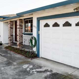 A residential house featuring a garage with a decorative wreath on the door.