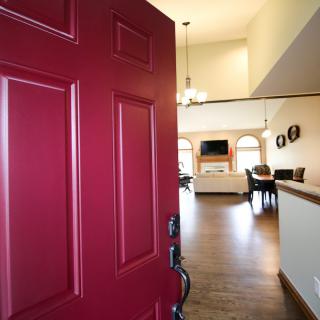 A welcoming entrance with a red door leading into a cozy living space.