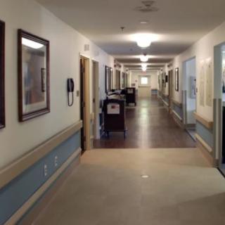 A clean and well-lit hallway in a healthcare facility.