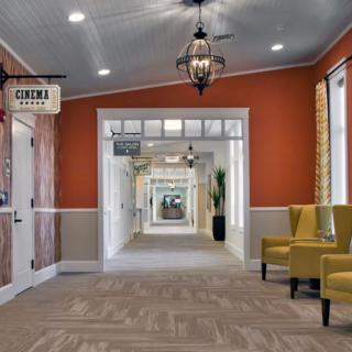 A well-decorated hallway with seating and ceiling lights.