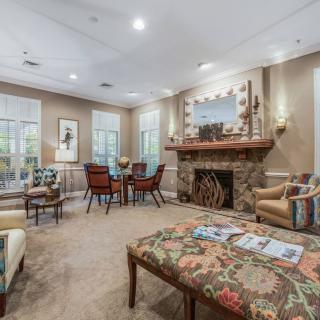 A cozy living room with a fireplace, comfortable seating, and elegant decor.