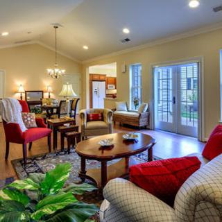 A bright and cozy living room featuring modern furniture and warm tones, perfect for relaxation and social gatherings.