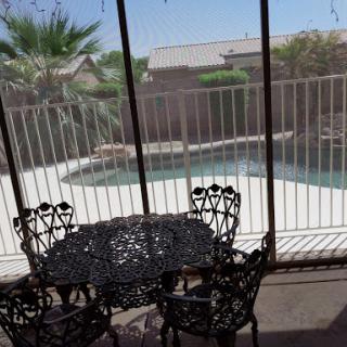 A serene patio view overlooking a pool, perfect for relaxation.