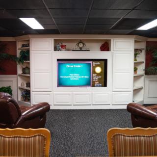 Cozy home theater setup with comfortable seating and built-in shelving.