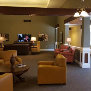 A comfortable lounge area with seating and a television.