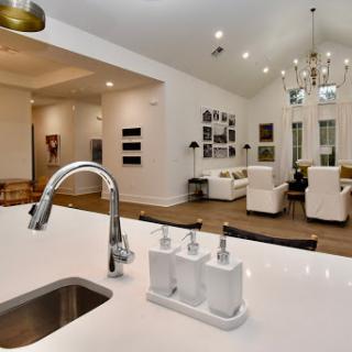 A stylish and modern open-concept kitchen that seamlessly connects to the living area, featuring elegant decor and contemporary furnishings.