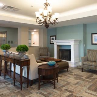 A cozy living room with elegant furniture and a warm fireplace.