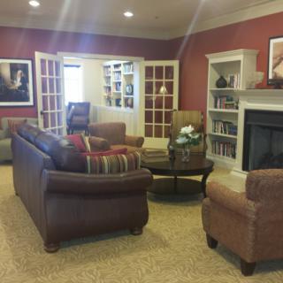 A cozy living room with comfortable seating and a fireplace.