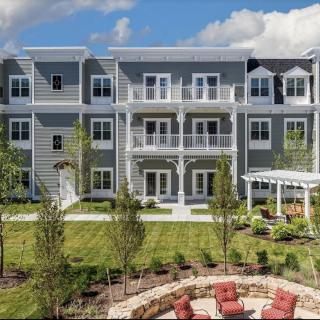 A modern apartment building with landscaped outdoor space and balconies.